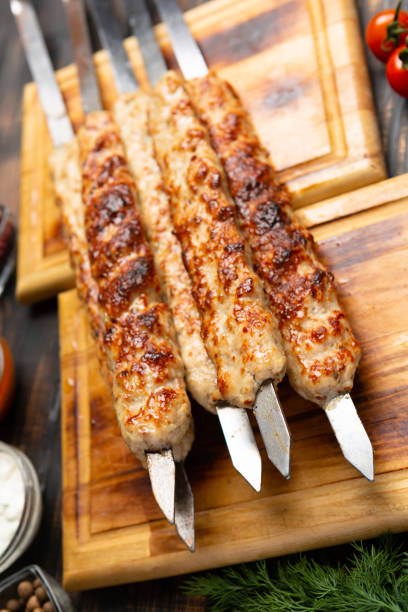 istock lula kebab with vegetables on cutting board 1303984105