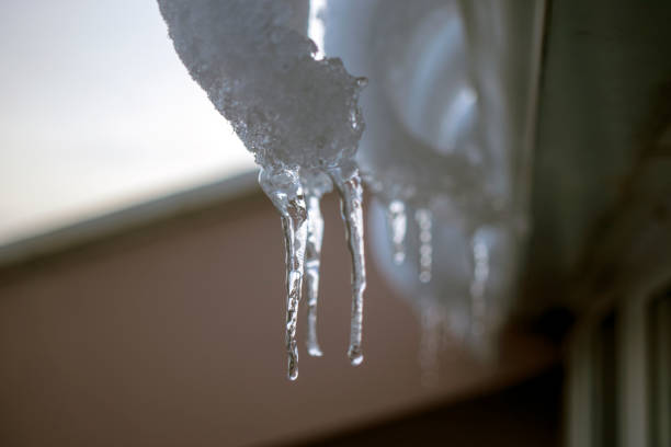 istock icicles hanging from the roof. 1303984198