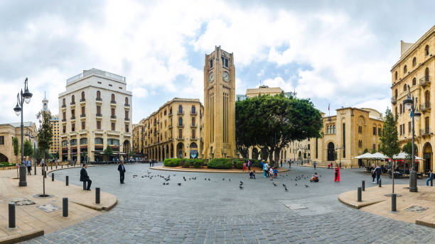 Nijmeh square in downtown Beirut with the iconic clock tower and the Lebanese parliament building, Beirut Beirut, Lebanon - April 08, 2018: Nejmeh square in downtown Beirut with the iconic clock tower and the Lebanese parliament building, Beirut, Lebanon lebanon beirut stock pictures, royalty-free photos & images