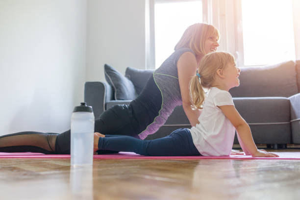 istock Mother and daughter exercising 1303986207