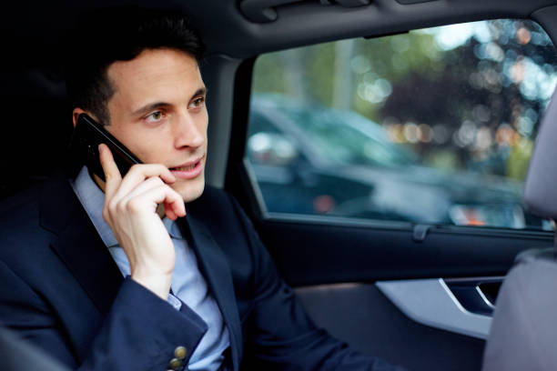 istock Business executive talking on mobile phone while traveling in car 1303987224