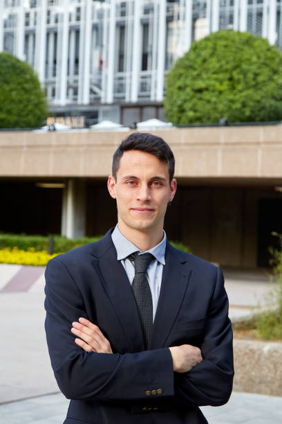 istock Young executive man looking at camera with arms crossed 1303987245
