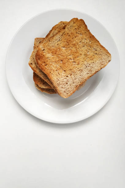 istock Square crispy and fragrant toast on a white plate, toast for breakfast. 1303990488