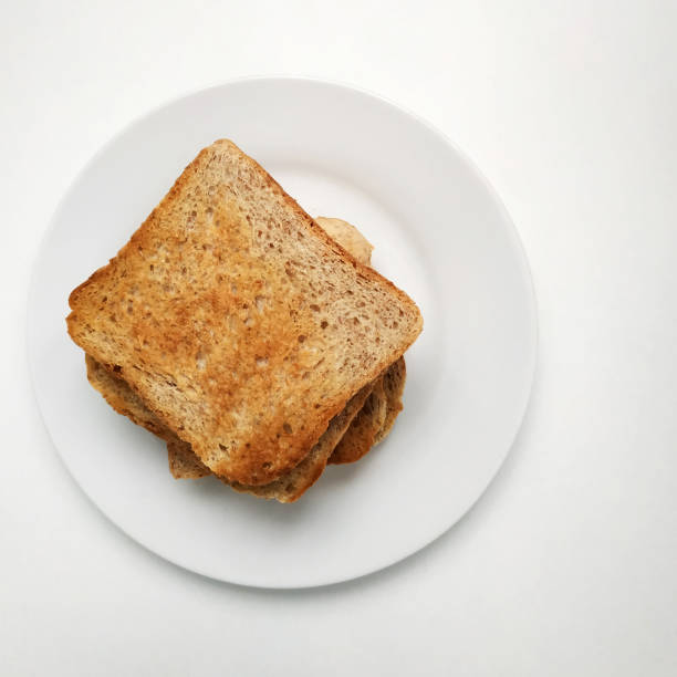 istock Square crispy and fragrant toast on a white plate, toast for breakfast. 1303990518