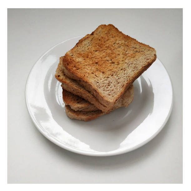 istock Square crispy and fragrant toast on a white plate, toast for breakfast. 1303990794