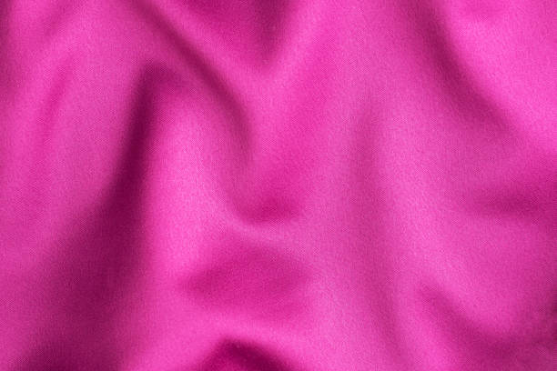 istock Pink crimson silk texture, background of clothing material. 1303991076
