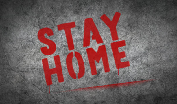 istock Stay home spray painted inscription on the concrete wall 1303992051