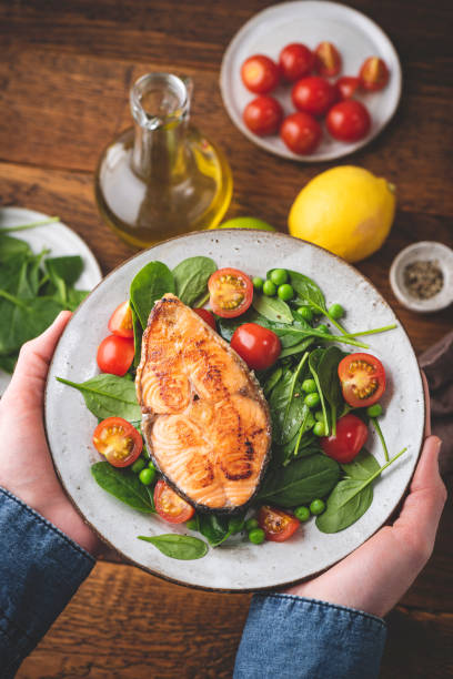 istock Grilled salmon with fresh salad, dinner meal 1303993304