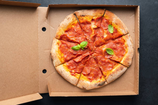 istock Pepperoni pizza in carton box 1303993383