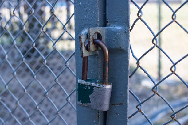 istock Large old padlock on a metal fence 1303993428