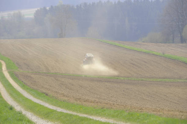Soil erosion in spring in agriculture, tractor on the field