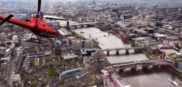 istock Helicopter Flying over Thames river, London, UK. 1303997056