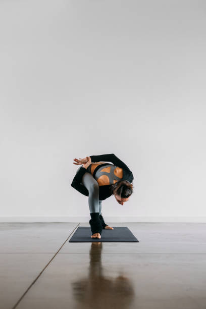 istock Woman practicing Yoga in Revolved Side Angle exercise, Parivrtta Parsvakonasana pose. 1303999668