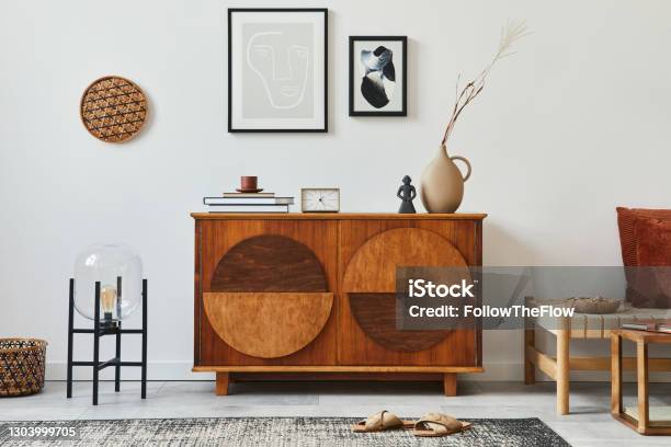 Stylish Retro Scandinavian Living Room Interior With Wooden Commode Mock Up Poster Frames Chiar Design Stool Cacti Lamp Clock Book Decoration And Personal Accessories In Home Decor Template Stock Photo - Download Image Now