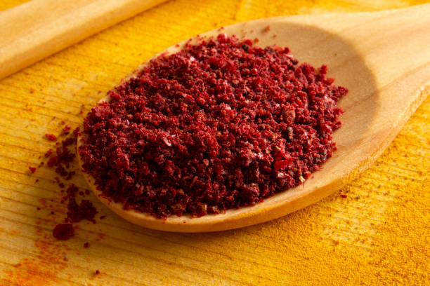 Healthy food concept. Sumac spice in the spoon. stock photo