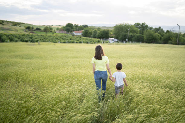 istock Brother and sister walking in a meadow 1304001128