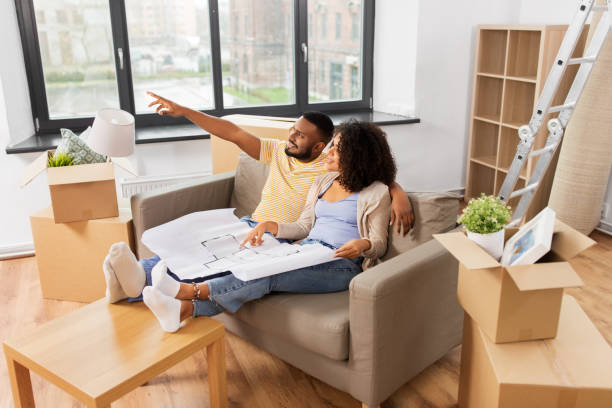 istock couple with boxes and blueprint moving to new home 1304002664