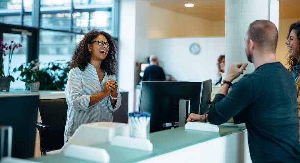 istock Smiling receptionist assisting people at municipal office 1304002955