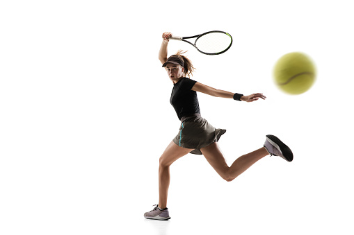 Catching. Young caucasian professional sportswoman playing tennis isolated on white background. Training, practicing in motion, action. Power and energy. Movement, ad, sport, healthy lifestyle concept.