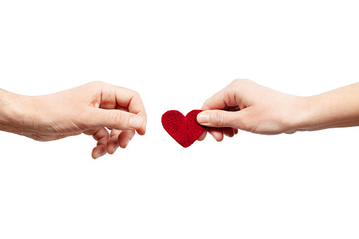 Female hand gives a male heart. Give love, a pair of lovers. Organ donor.