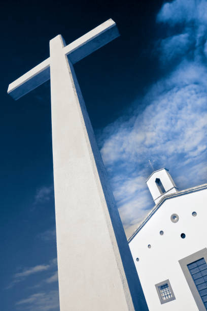 istock Christian high cross with small church against a dramatic sky 1304009678