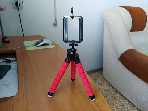 Red color tripod on the table