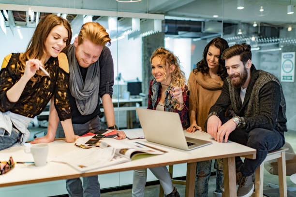 istock Happy multi-tasking freelancers working at casual office. 1304012383