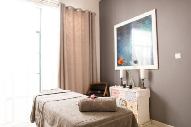 istock Luxury spa treatment room with towel and candles 1304014616