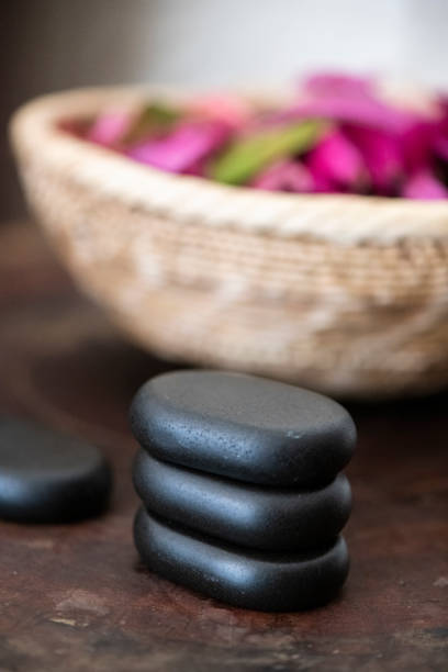 istock Black spa treatment pebbles and pink potpourri 1304014715