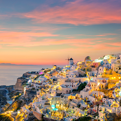 Sunset night view of Famous Greek village Oia on Santorini island in Greece. Santorini is iconic travel destination in Greece, famous of its sunsets and traditional white architecture