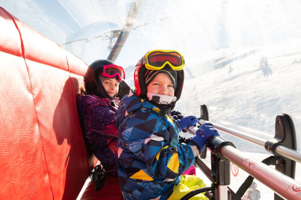 istock Kids sitting on a ski lift 1304015869