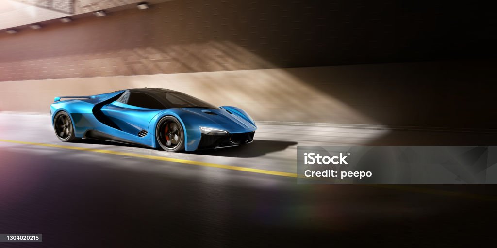 Blue Sports Car About To Travel Through Tunnel At Speed A generic blue sports car on a road travelling at speed, about to move into a tunnel or underpass. The car is highlighted by shots of sunshine at the tunnel mouth. With motion blur to the background and car wheels, and slight lens flare. Sports Car Stock Photo