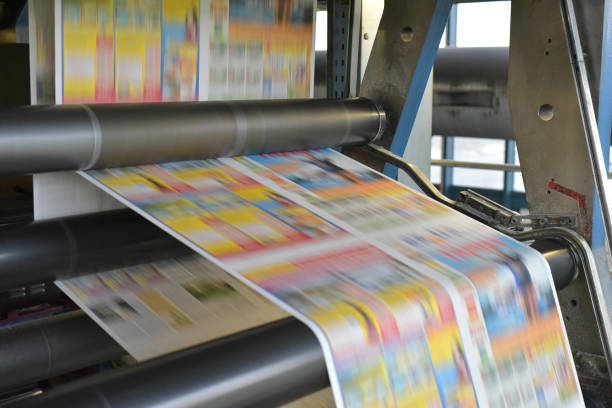 roll offset print machine in a large print shop for production of newspapers & magazines roll offset print machine in a large print shop for production of newspapers & magazines rolled up magazine stock pictures, royalty-free photos & images