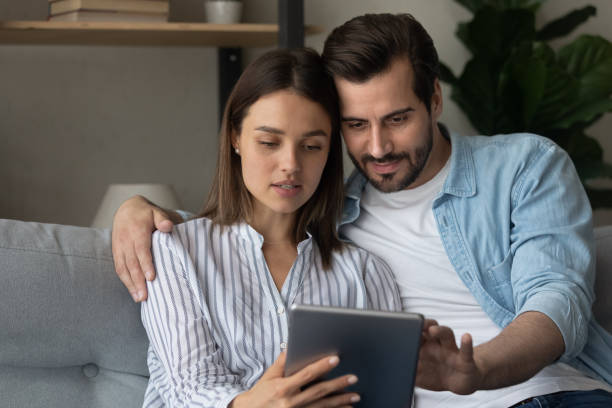 istock Young spouses hold digital pad buy goods order service online 1304021737