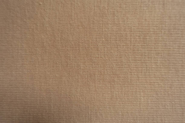 istock Texture of simple beige cotton jersey fabric 1304023140