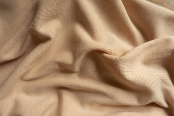 istock Rumpled simple beige cotton jersey fabric from above 1304023150