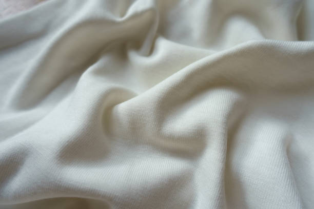 istock Pure white cotton jersey fabric in soft folds 1304023310