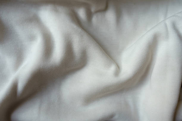 istock Simple white cotton jersey fabric in soft folds 1304023323