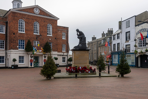 Epsom Surrey London, April 09 2022, Man Walking  Through Market Square Using Mobile Phone With People And Families In Background