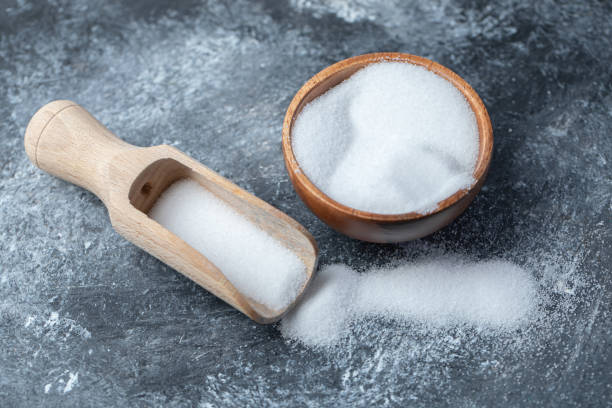 istock Salt in a wooden spoon on a marble background 1304024159