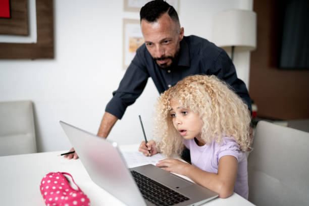 istock Father helping daughter with homeschooling 1304024550