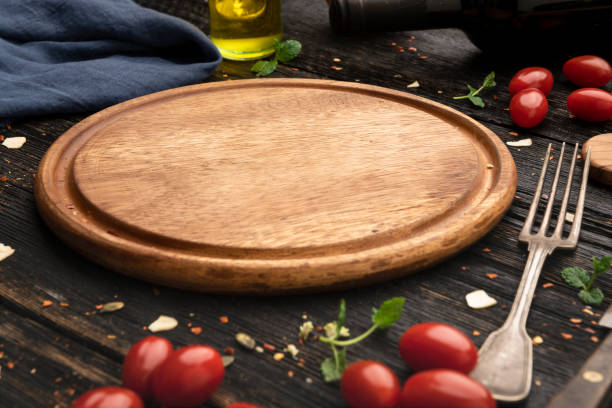 istock Empty wooden pizza board and pizza cooking ingredients 1304025570