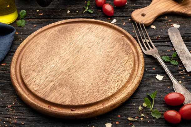 istock Empty wooden pizza board and pizza cooking ingredients 1304025576