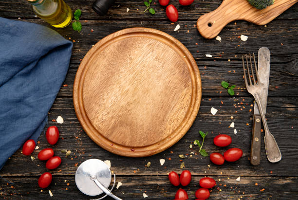 istock Empty wooden pizza board and pizza cooking ingredients 1304025737