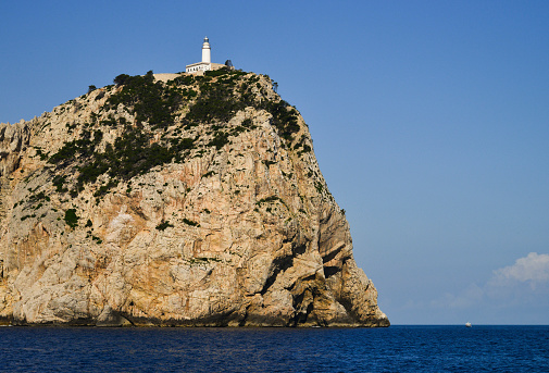 Lighthouse on edge of coastal cliff, Majorca, Spain