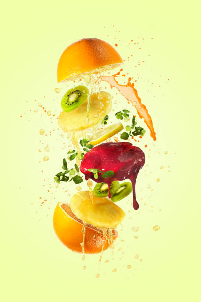 Flying tasty fruit burger isolated over light yellow background.