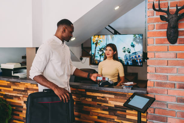 istock Tourist paying contactless at hotel reception 1304031405
