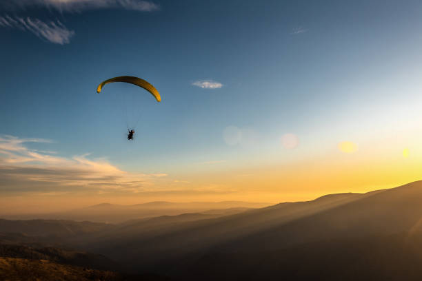 istock paraglider flies over the mountains 1304031589