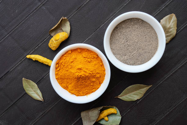 istock Turmeric powder and black pepper powder 1304031902