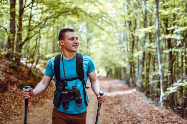 istock Front View Of Smiling Male Hiker And His Binoculars In Forest 1304032183